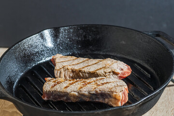 Marbled beef steak on a grill pan.