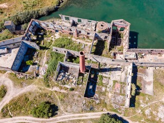 Aerial view of an abandoned building in disuse in the middle of the countryside near the industrial area, Aldeia de Paio Pires, Setúbal, Portugal.