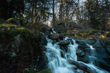 Long exposure photo of a beautiful waterfall in the Swedish forest.