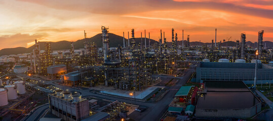 Panorama view of Chemical oil refinery plant, power plant and metal pipe on sunset sky background,...