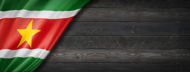 Suriname flag on black wood wall banner