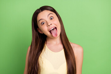 Portrait of young satisfied person open mouth tongue out look camera isolated on green color...