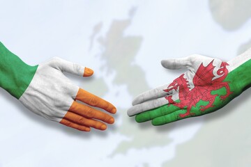 Wales and Ireland - Flag handshake symbolizing partnership and cooperation
