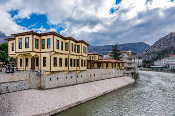 Fototapeta na wymiar Old Ottoman houses evening panoramic view by the Yesilirmak River in Amasya City. Amasya is populer tourist destination in Turkey.