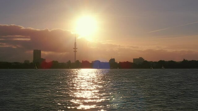 beautiful time lapse of a sunset on the Alster in Hamburg with many sailing boats