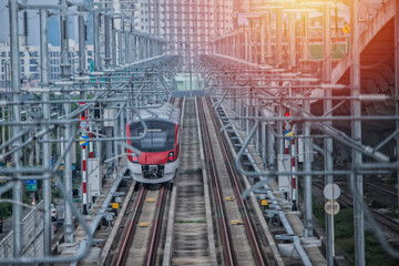 Electric train  red-white  color  on railway in Bangkok, Thailand. New  Electric train in Bangkok, Thailand.
