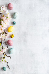 Easter eggs and spring flowers, top view