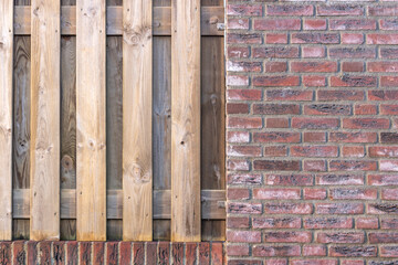 Background of a wooden fence and a wall full of bricks.