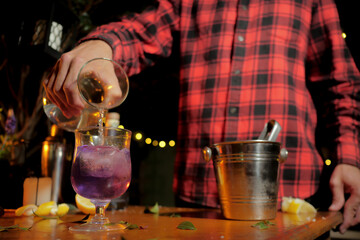 Man preparing drink with lemon