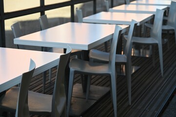 Row of empty white restaurant terrace tables