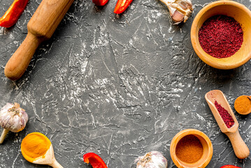 Professional kitchen with spices for cook on gray background top view mock-up