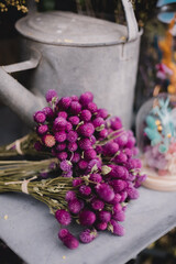 Bouquet of flowers next to an old watering can