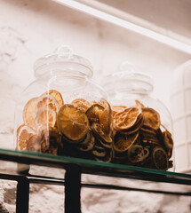 Glass jars with dried oranges inside