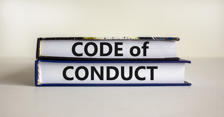 Code of conduct symbol. Concept words 'Code of conduct' on books on a beautiful white table, white...