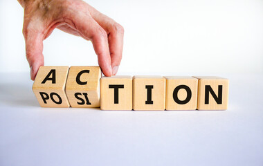 Action or position symbol. Businessman turns wooden cubes and changes the word position to action. Beautiful white background, copy space. Business and action or position concept.