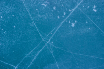 Blue cracked surface of frozen lake background