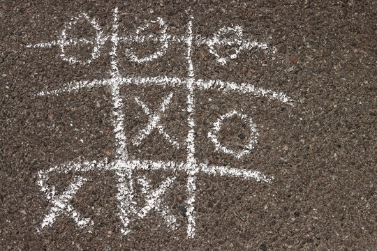 tic-tac-toe chalk on the asphalt, children's drawing on the sidewalk