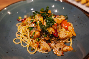 Basil spaghetti on a blue plate