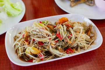 Papaya salad on the plate on the dining table