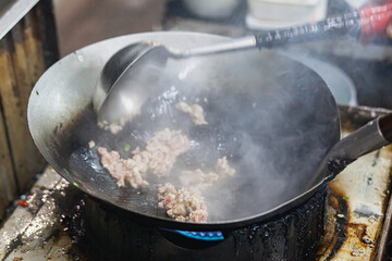 Minced pork that is fried in a black pan