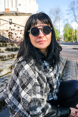 portrait of a girl in round black sunglasses