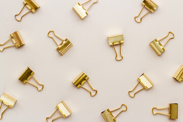 Flat lay of paper binder clips, office supplies pattern