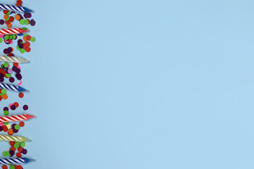 row of Colorful birthday candles on a blue background. Celebration party. Copy space for text