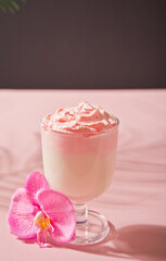 Glass of rose or strawberry iced Dalgona whipped drink coffee