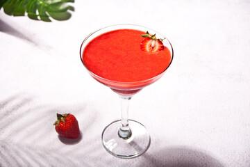 Cold strawberry margarita or daiquiri cocktail with lime and rum
