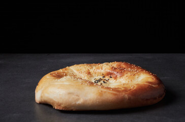 Sliced homemade bread on a cutting board in the kitchen on a wooden background.