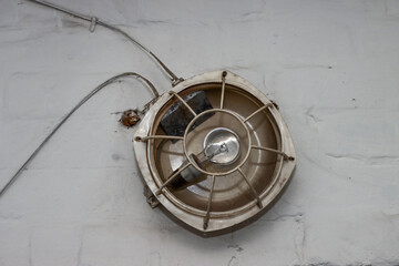 Old industrial lamp with protective grille