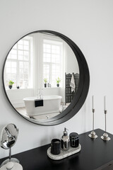 Makeup table and round mirror in contemporary bathroom