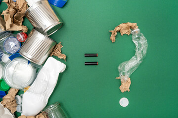 Question mark made of plastic and paper waste