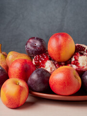 Still life of fresh fruit with pomegranate, grapes, pears and plums