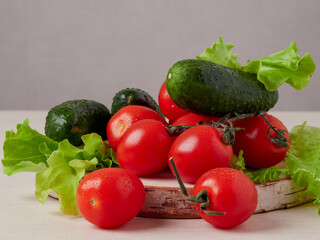 Full bowl of low calories salad with tomato, pepper, cucumber lies on scratched dark concrete. Vegetarian, dieting, healthy food. Close-up