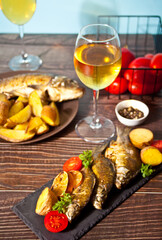 Grilled fish on plate with lemon and vegetables