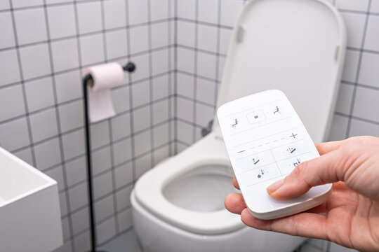 remote Control with buttons of the smart toilet bowl. high technology automatic modern flush toilet