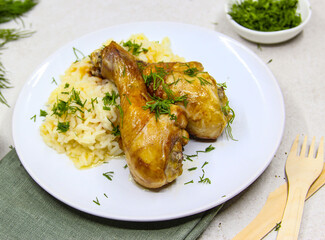 Roasted chicken drumsticks white rice with green herbs. Traditional asian dish.