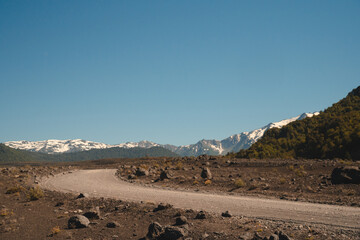 mountain road with a volcano in the background