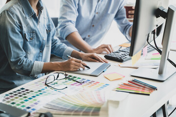 Graphic design using graphics tablet .drawing creative logo design brand designer sketch with Color swatch samples.