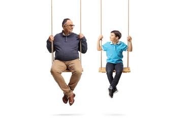 Grandfather swinging with his grandson