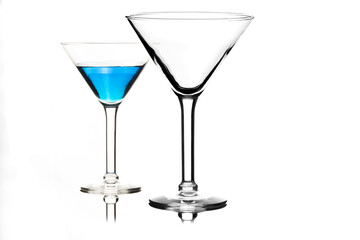 Martini glasses isolated on white with blue drink in one glass