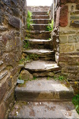 old stone staircase made of large stone slabs in a medieval european castle ruin