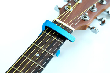 Acoustic guitar neck with a blue capo, music accessories