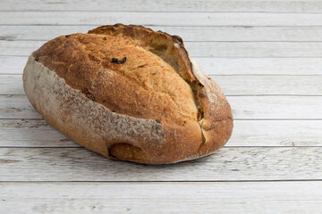 a loaf of crusty  French bread on a wooden table
