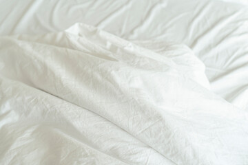 Fototapeta na wymiar Unmade bed; wrinkled pillowcases, bed sheet and duvet