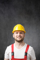 Happy, smiling worker with yellow hard hat