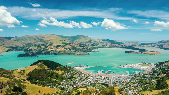 Clouds motion fast over Lyttelton Harbour bay in beautiful New Zealand nature countryside in sunny summer landscape Time lapse