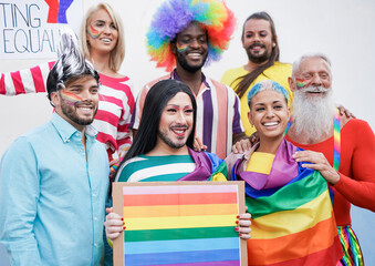 Happy multiracial people at gay pride parade with banner - LGBTQI concept - Homosexual and transgender rights
