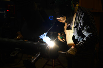 Worker operating an angle grinder and making lots of sparks